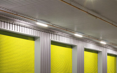 LED Batten Lights mounted above yellow warehouse roller doors
