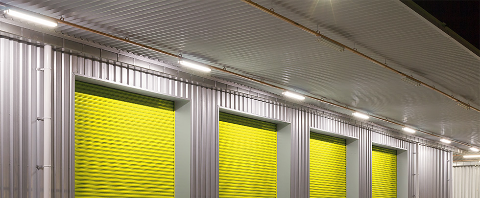 LED Batten Lights mounted above yellow warehouse roller doors