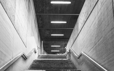 Concrete stairwell lit up by batten lights